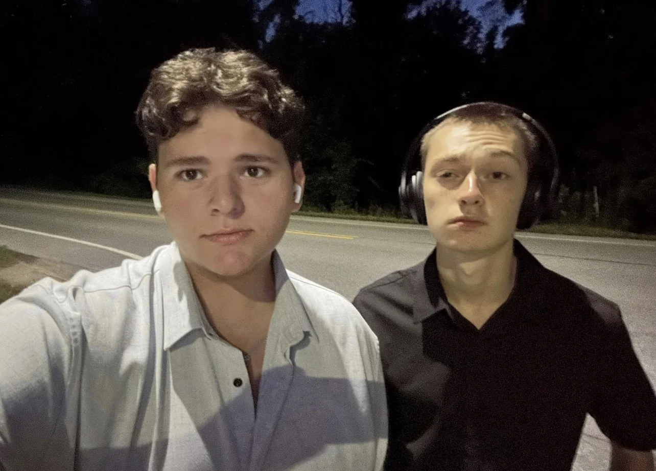 Dominic and Derek together outdoors at night