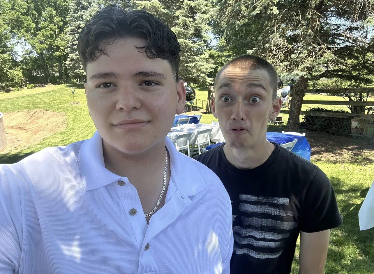 Dominic and Derek together outside during the day